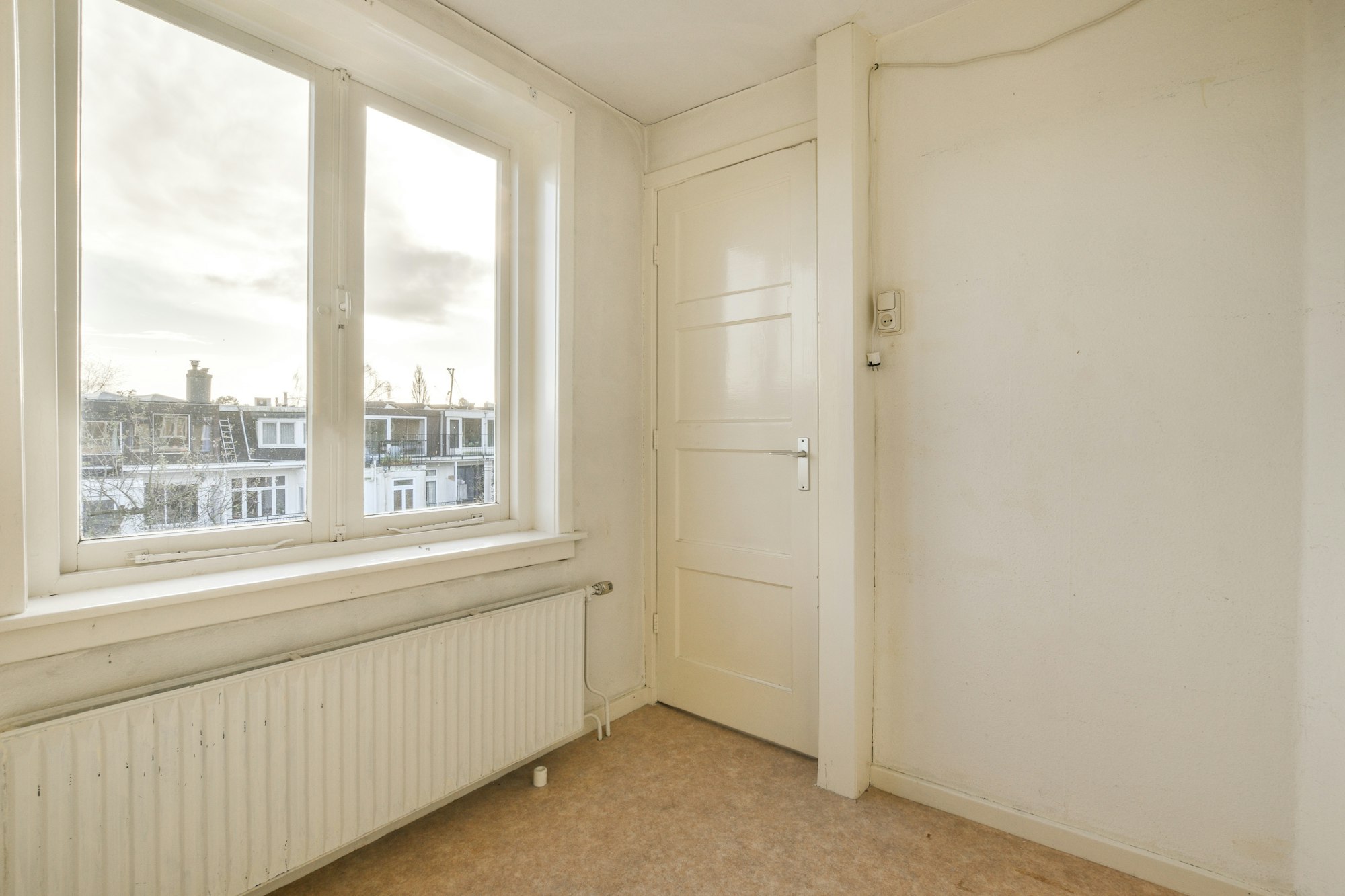 a room with a window and a door and a